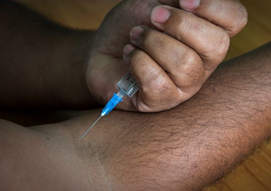 Cropped Image Of Man Injecting Arm