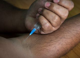 Cropped Image Of Man Injecting Arm