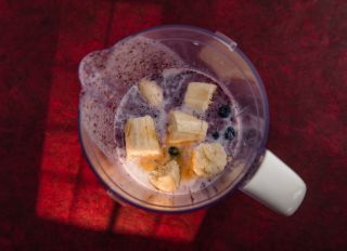 Blueberry smoothie ingredients in countertop blender