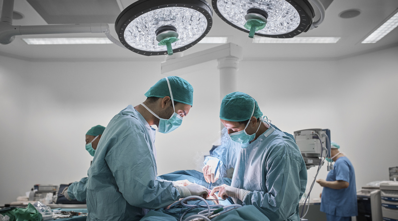 Doctors operating patient for breast surgery