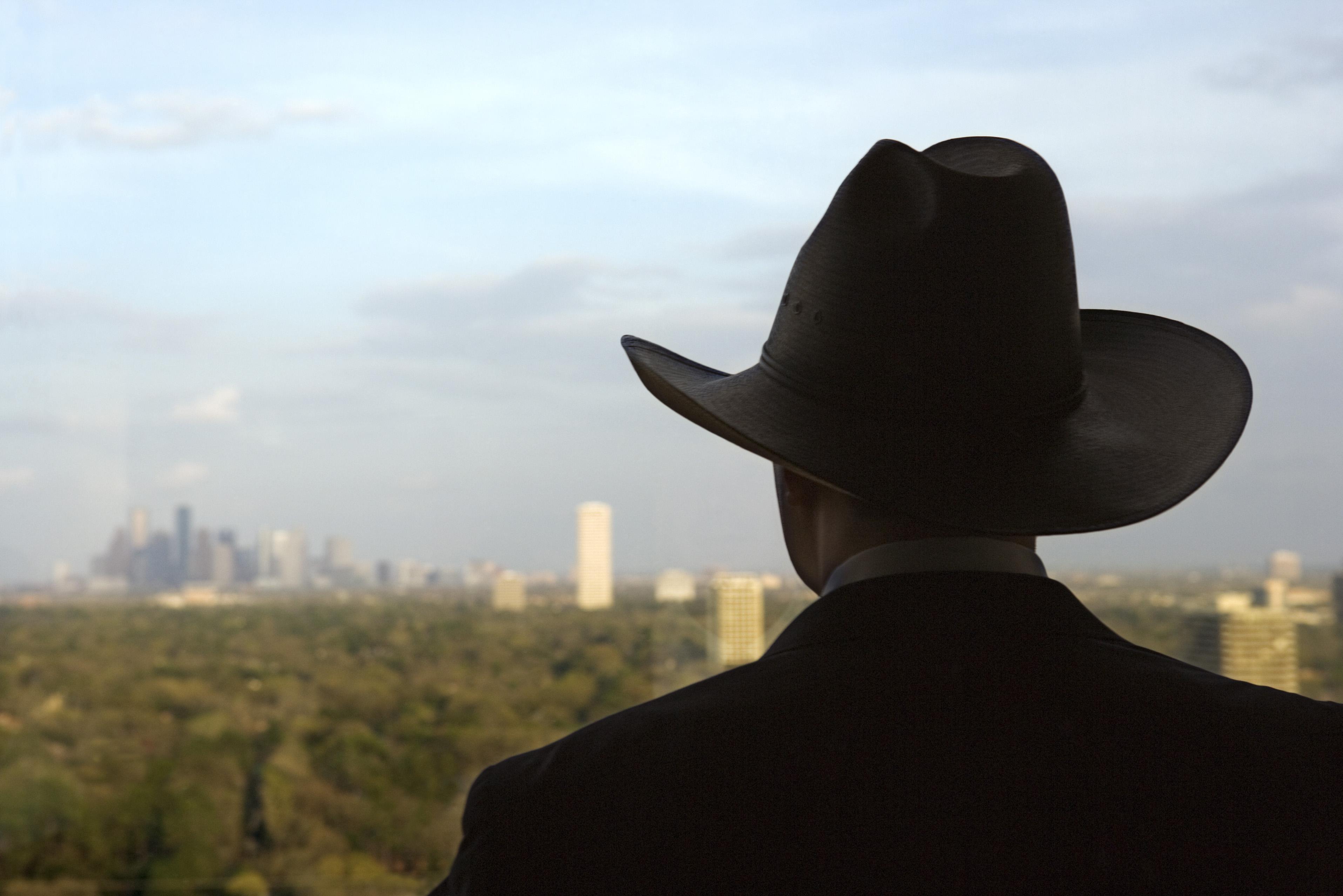 Man wearing cowboy hat gazing at skyline