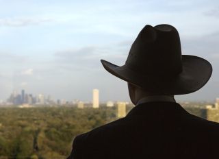 Man wearing cowboy hat gazing at skyline