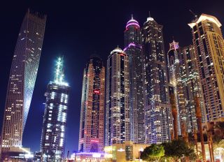Low Angle View Of Illuminated Modern Skyscrapers At Dubai Marina During Night