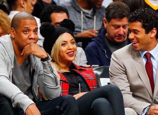 Recording artists Jay-Z, Beyonce, and Russell Wilson of the Seattle Seahawks attend a game between the Brooklyn Nets and the Philadelphia 76ers at Barclays Center on February 3, 2014