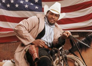 Cowboy in front of American Flag.