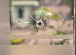 Bullet Hole on Glass Window