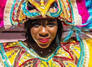 Bahamas, Nassau, Woman posing in a colorful carneval costum