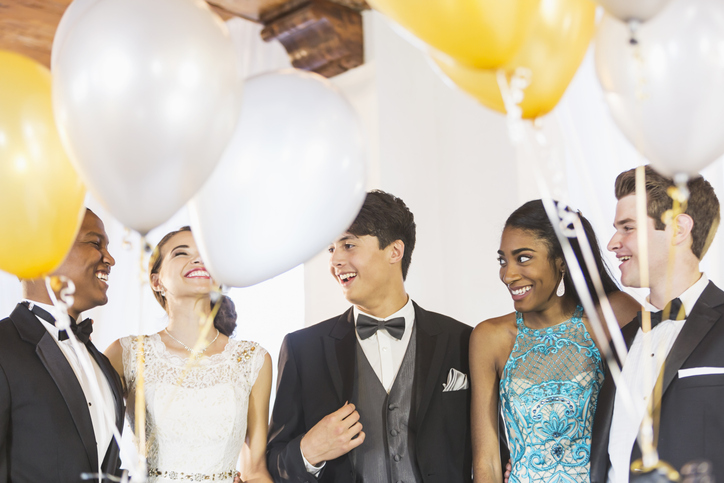 Teenagers and young adults in formalwear at party