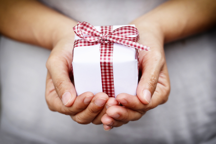 Midsection Of Person Holding Gift Box