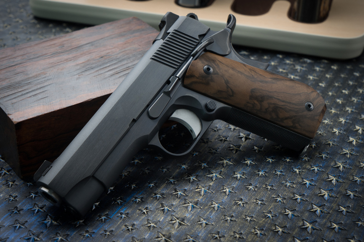 side view of hand gun pistol with gun magazine