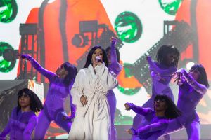 Cardi B Performs in a Bathrobe at Bonaroo after Busting Open Dior Sequined jumpsuit