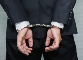 Midsection Rear View Of Businessman With Handcuffs