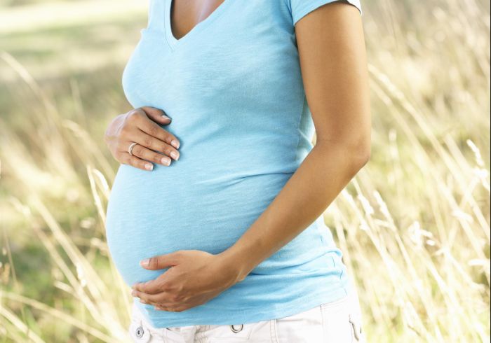 Pregnant woman outdoors in countryside