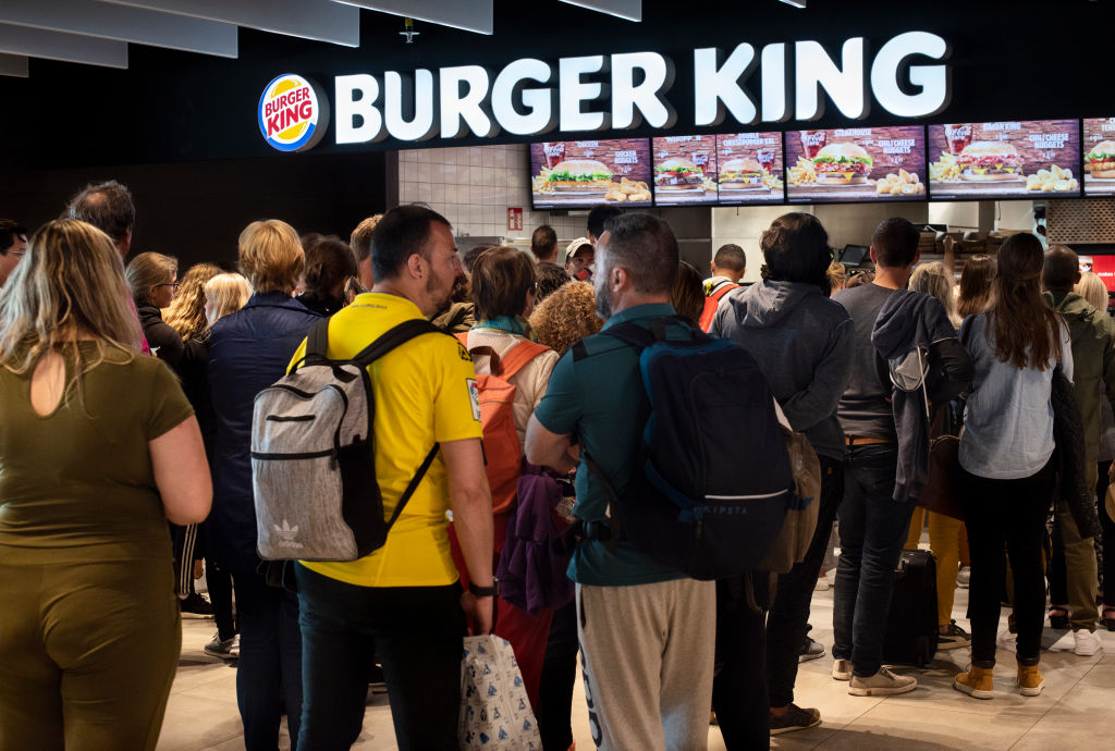 Customers in a queue in front of an American fast-food...