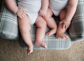 7 month Fraternal Twin Legs in a Chair