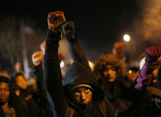 A young protester raised his fist during a moment of silence for Jamar Clark during a concert in front of the Fourth Precinct on Plymouth Avenue North Tuesday November 24 2015 in Minneapolis, MN.] Jerry Holt/ Jerry.Holt@Startribune.com