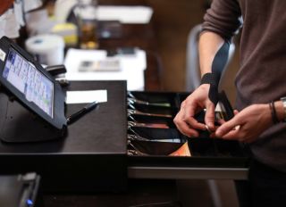 a Restaurant manager using the cash register.