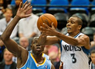 DAVID BREWSTER ¬• dbrewster@startribune.com Tuesday 10/12/10 Minneapolis TIMBERWOLVES vs. DENVER NUGGETS ] Wolves Sebastian Telfair gets ready to pass the ball to a teammate. Denver Eric Boateng was applying pressure.