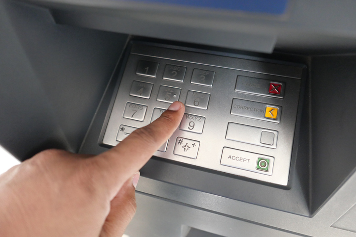 typing password on ATM card machine