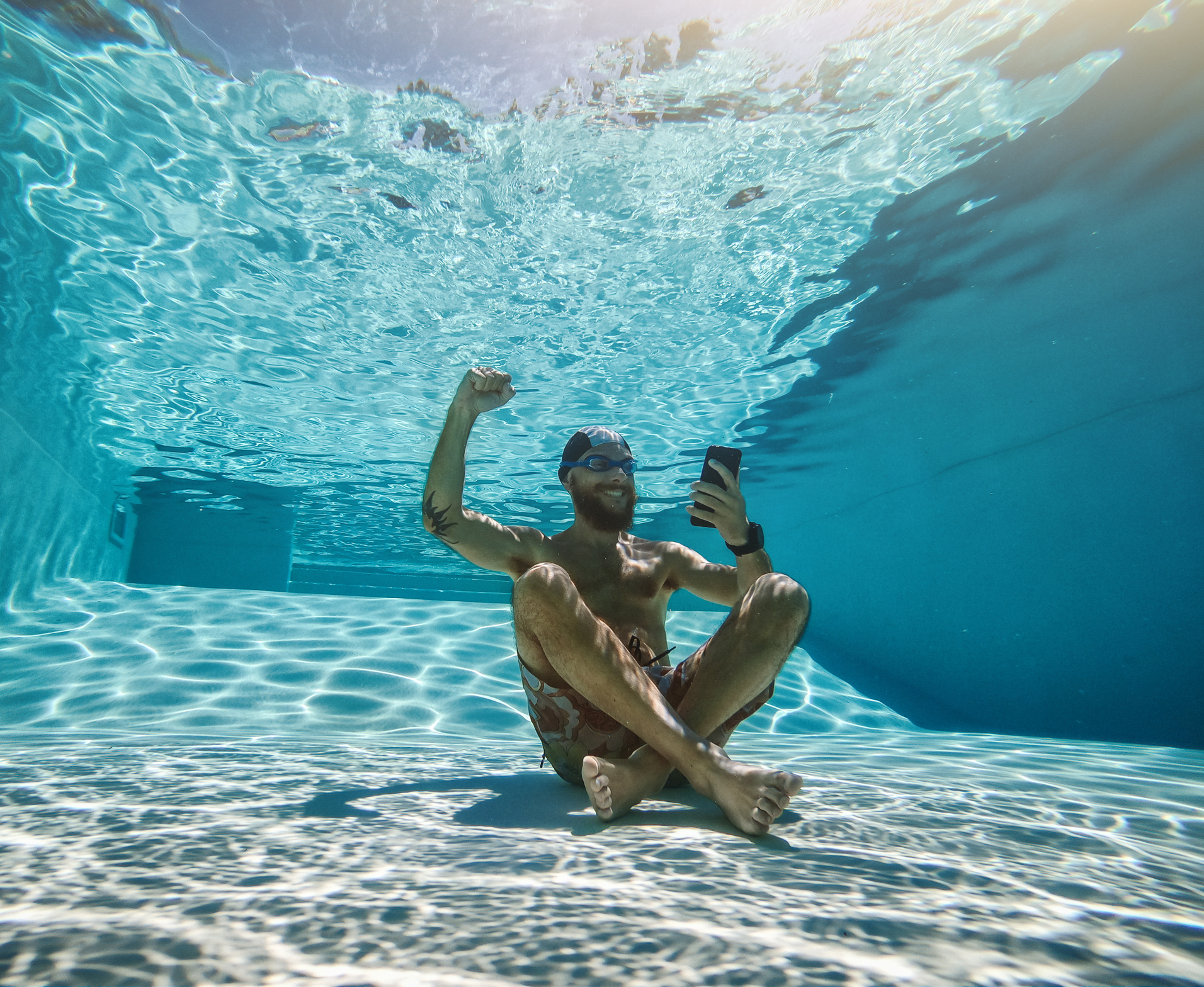 Gambling addicted man using mobile phone underwater