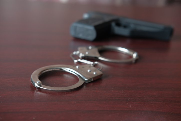 handcuff and pistol on table