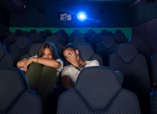 Young couple watching a scary movie