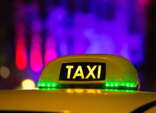 Taxis sign seen at night on Kungsportavenyen in Gothenburg,...