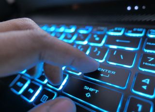 hacker hand typing on keyboard