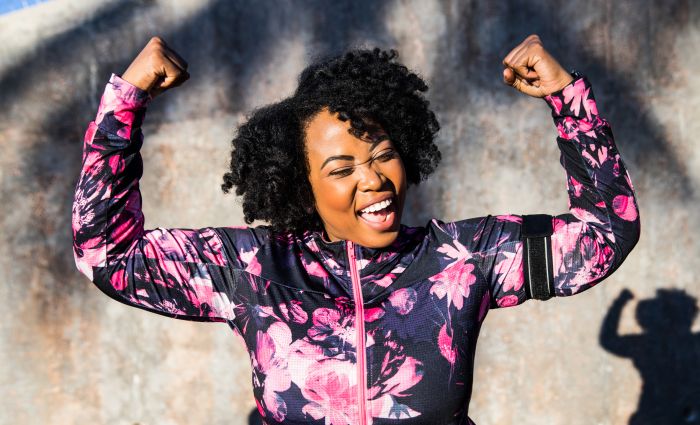Funny portrait of a young black curvy woman during a training session - stock photo