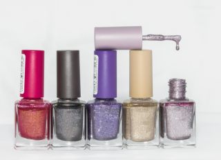 Close-Up Of Nail Polish Bottles Against Gray Background