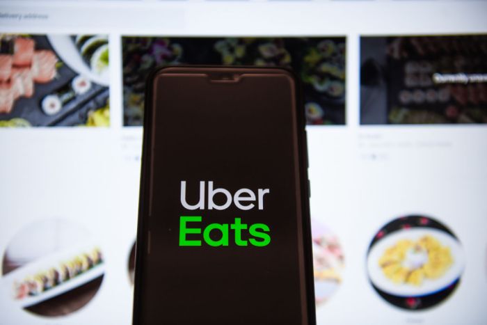 In this photo illustration an Uber Eats logo displayed on a...