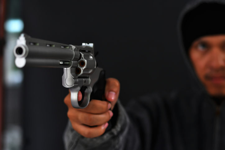 Masked Armed robbers pointing a handgun