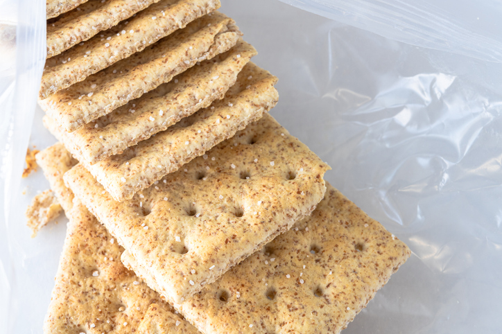 A group of whole wheat soda crackers in an open package