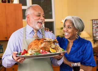 African American man serving Thanksgiving turkey - stock photo