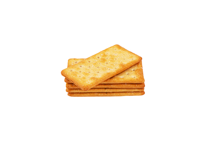 Stack of Delicious salty crackers isolated on white background