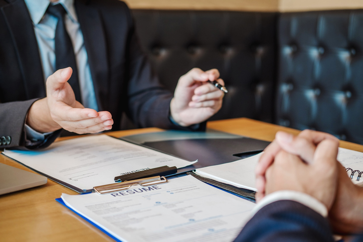 Cropped Hands Of Businessman Interviewing Candidate In Office