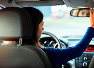 Teenager Having Driving Lesson With Female Instructor