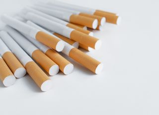 A Pack Of Cigarettes With An Air Filter On A White Table. Prevention Of Bad Habits And Addictions. Selective Focus. Copy Space For Text.