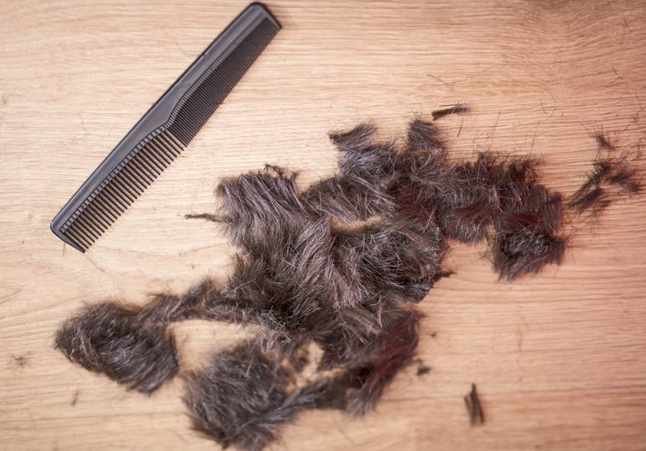 Hair lying on the floor of a hairdresser salon after a haircut.