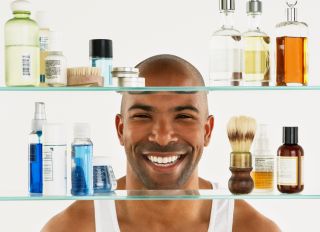 African American man looking in medicine cabinet - stock photo