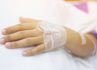 Cropped Hand Of Person With Iv Drip