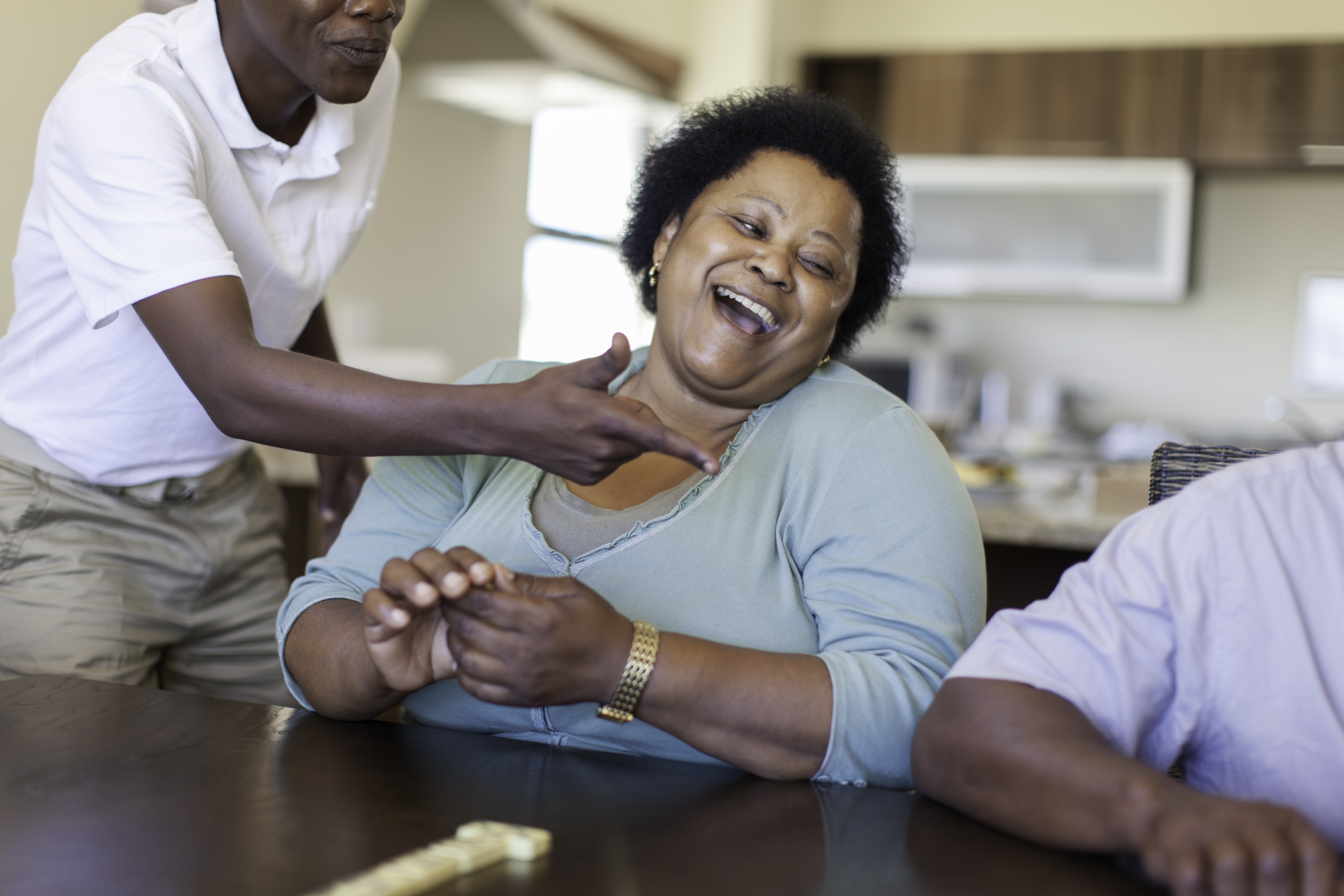 African male pointing at his grandfather for cheating
