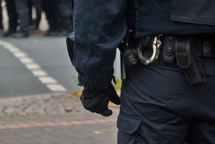 Midsection Of Police Officer Standing On Road