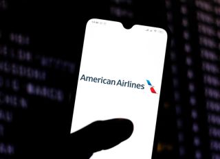 In this photo illustration the American Airlines logo is...