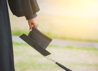 Cropped Image Of Person Holding Mortarboard