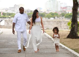 Kim Kardashian West, Kanye West and North West wear all white