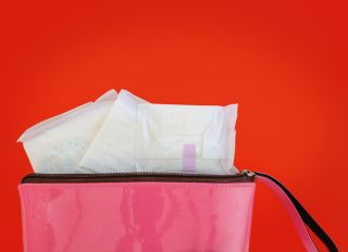 Close-Up Of Sanitary Pads In Bag Against Red Background