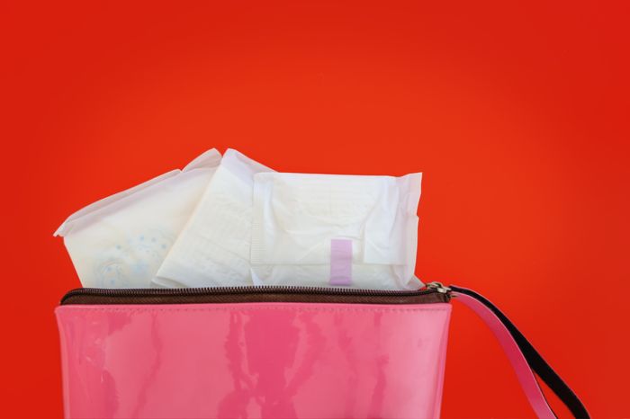 Close-Up Of Sanitary Pads In Bag Against Red Background