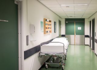 Bed in hospital corridor