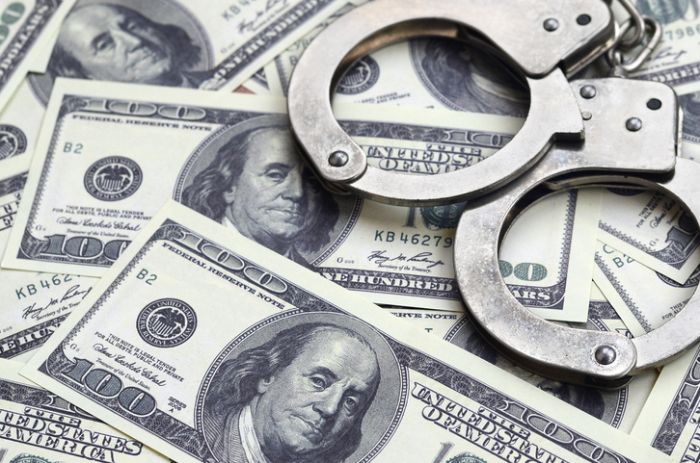 High Angle View Of Handcuffs On Us Currency